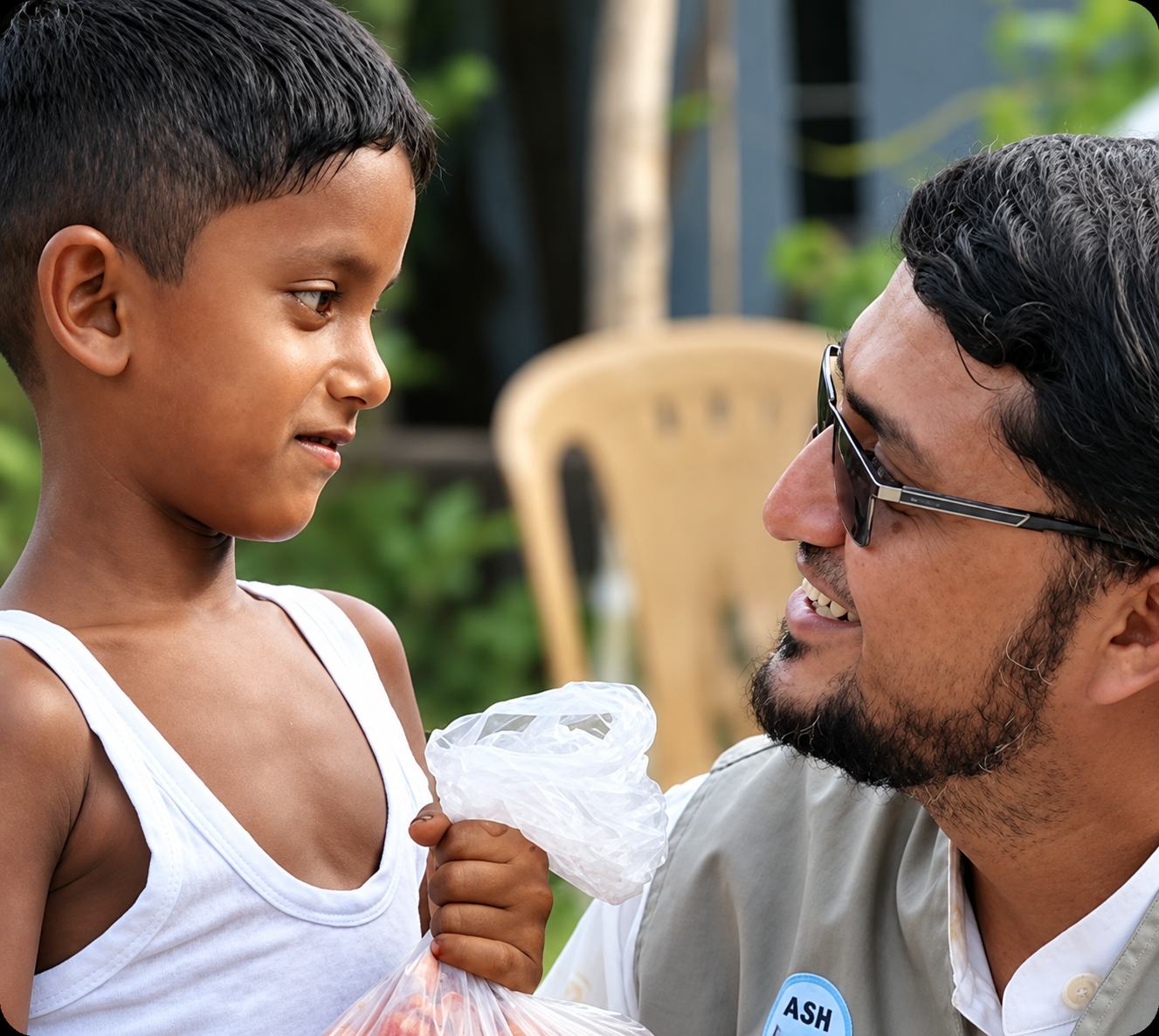 ASH Foundation leadership with a child during field work